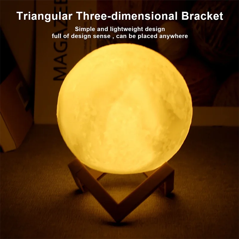 Vintage-style warm light moon lamp with wooden stand placed on a table, featuring decorative typography in the background