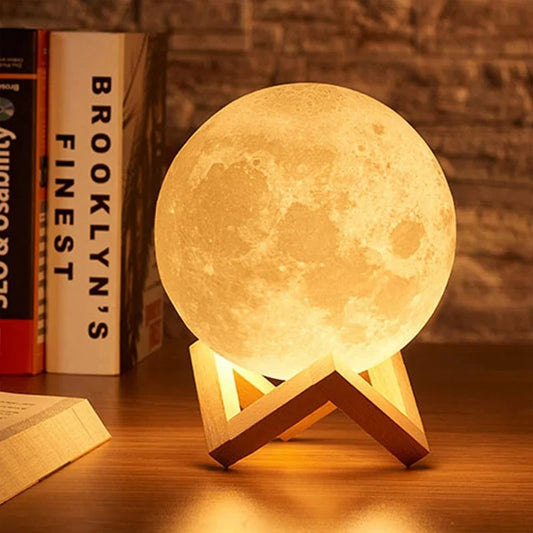 Warm light moon lamp placed on a wooden stand on a table